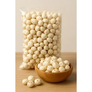 A wooden bowl filled with 5 Soota Raw Makhana, with a plastic bag of additional puffed lotus seeds in the background, highlighting premium quality and bulk packaging.