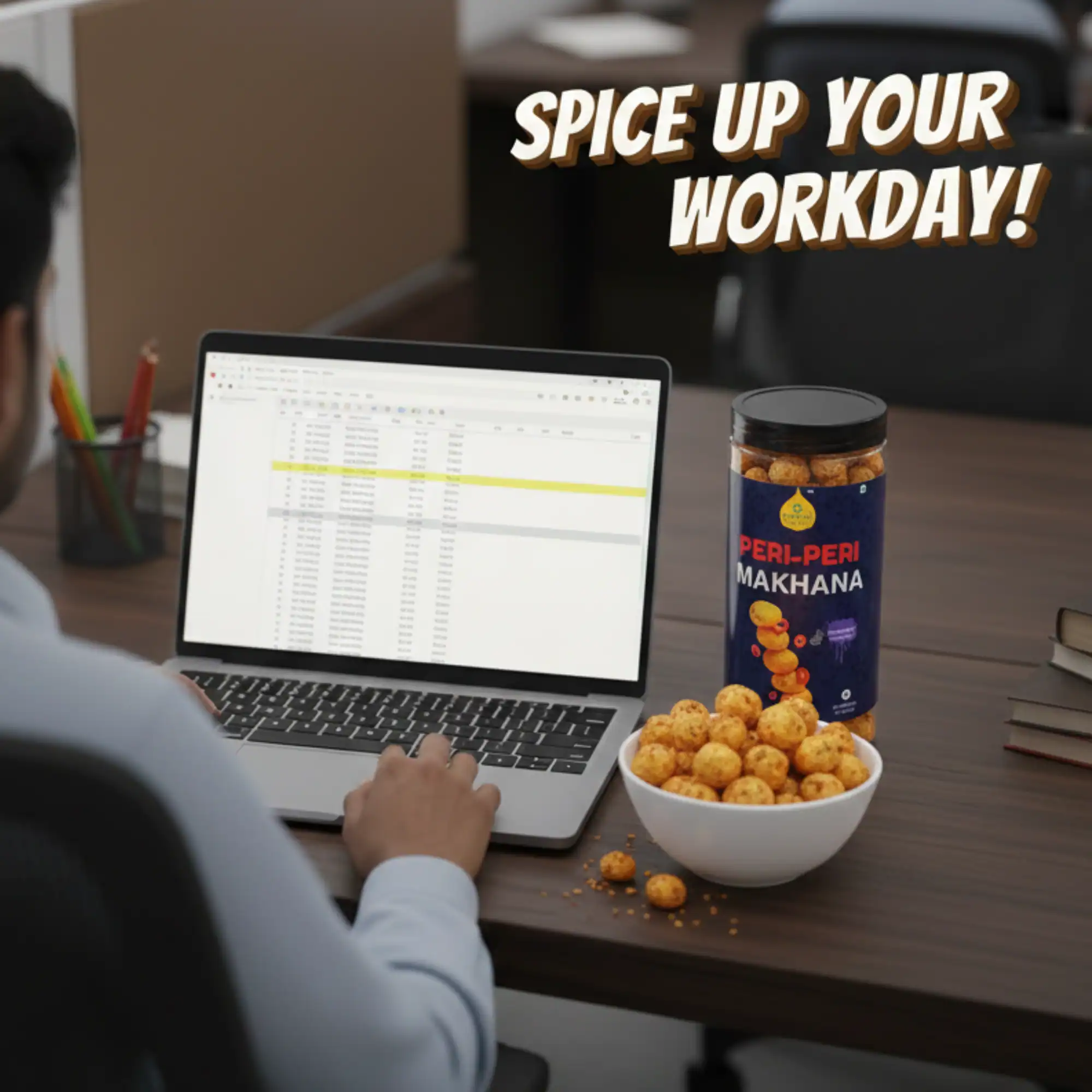 Person working on a laptop with a bowl of Health Ratna Peri-Peri Makhana for a healthy workday snack